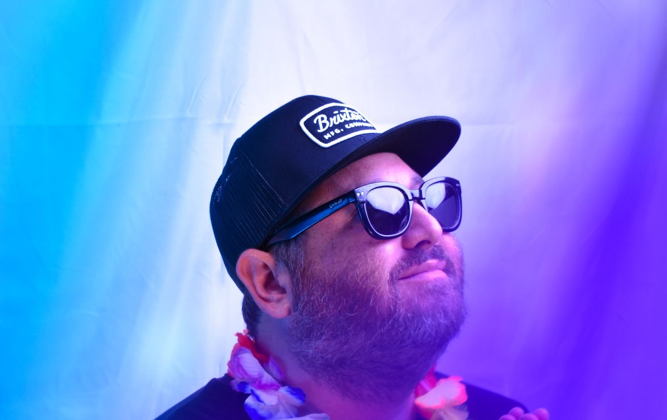 Hans Nüsslock with a lei under blue and purple light